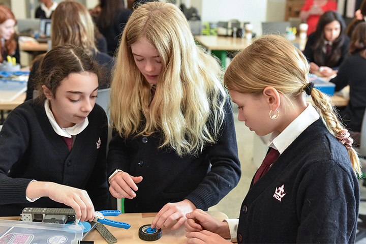 ARK Educate middle school students working together on a robotics project in a classroom